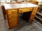 (R2) WOOD DESK WITH FAUX LEATHER TABLE TOP; WOOD GRAIN DESK THAT HAS A FAUX LEATHER TOP WITH GOLD