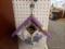 (R1) BIRDHOUSE; HAND PAINTED WOODEN BIRD HOUSE WITH AN OPENING BOTTOM LATCH. MEASURES 9 IN X 6 IN X