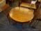 (R4) ROUND WOODEN DINING TABLE; ROUND DINING TABLE ON A LARGE PEDESTAL BASE WITH 4 LEGS THAT CURL AT