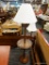 (R4) WOODEN LAMP; TURNED WOODEN FLOOR LAMP WITH A ROUND SHELF AT THE MIDDLE OF THE LAMP. MEASURES 4