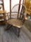 (R4) ROCKING CHAIR; WOODEN BARREL ROCKING CHAIR WITH A BANNISTER BACK AND TURNED LEGS. MEASURES 26