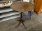(R5) SIDE TABLE; PEDESTAL WOODEN SIDE TABLE WITH A ROUND TABLE TOP AND 4 METAL CAPPED CLAW FEET.