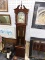 (R6) GRANDFATHER CLOCK; DARK STAINED WOODEN GRANDFATHER CLOCK WITH A BROKEN ARCH PEDIMENT TOP AND