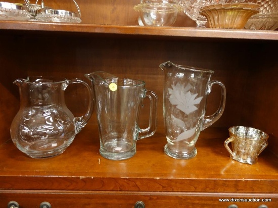 (R1) LOT OF GLASS PITCHERS AND CUP; 4 PIECE LOT TO INCLUDE 3 LARGE GLASS PITCHERS, ONE HAS ETCHED