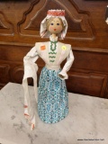 (R2) DOLL; VINTAGE HOMEMADE DOLL ON A STAND. MEASURES 20 IN TALL.
