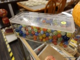 (R2) MARBLES; PLASTIC BOX FULL OF MARBLES OF DIFFERENT COLORS AND SIZES. BOX MEASURES 10 IN X 4 IN X