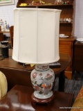 (R2) FLORAL PATTERN LAMP; HAS A WOODEN CARVED BASE AND FLORAL PATTERN PORCELAIN BODY. IS IN