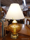 (R4) TABLE LAMP; LARGE PUMPKIN SHAPED AMBER GLASS LAMP SITTING ON A BRASS BASE. COMES WITH A CREAM