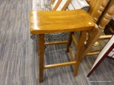 (R4) STOOL; WOODEN BAR STOOL WITH A ROUND BOTTOM SEAT. MEASURES 18 IN X 15 IN X 29 IN.