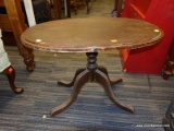 (R4) SIDE TABLE; WOODEN OVAL SIDE TABLE WITH 1 PEDESTAL LEG LEADING TO 4 REEDED SPLAY FEET. MEASURES