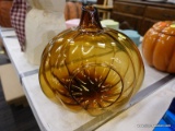(R5) GLASS PUMPKIN CANDLE HOLDER; AMBER GLASS PUMPKIN SHAPED CANDLE HOLDER WITH A HOLE IN THE TOP OF