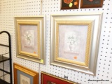 (R6) FRAMED PRINT; PAIR OF WHITE FLOWERS IN A VASE PRINTS. SITS IN A GOLD AND SILVER TONED FRAME AND