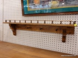 (R6) WALL HANGING COAT RACK; WOODEN WALL HANGING COAT RACK WITH A SHELF AND A RAILING AROUND THE