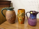 (R1) POTTERY PITCHERS; 3 PIECE LOT OF WATER PITCHERS OF DIFFERENT DESIGNS AND SIZES.
