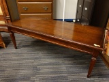 (R2) WOODEN COFFEE TABLE; RECTANGULAR WOODEN COFFEE TABLE WITH TAPERED BOX FEET. MEASURES 46 IN X 19