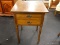 (R2) END TABLE; WOODEN END TABLE WITH 2 DRAWERS THAT HAVE METAL BATWING PULLS. HAS REEDED DETAILING