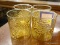 (R2) AMBER GLASSES; 4 MATCHING VINTAGE AMBER GLASSES WITH FLOWER DESIGNS ON THE SIDE.