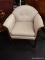 (R3) ARM CHAIR; UPHOLSTERED ARM CHAIR WITH A SCALE LIKE FABRIC AND ROLL ARMS. SITS ON A DARK STAINED