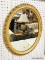 (WALL) WALL HANGING MIRROR; OVAL MIRROR SITTING IN A MUSTARD YELLOW PAINTED ORNATE FRAME. MEASURES
