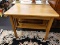 (R1) BREAKFAST TABLE; WOODEN TABLE WITH A LOWER SHELF. MEASURES 3 FT X 1 T 11.5 IN X 28.75 IN.