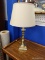 (BWALL) BRASS TABLE LAMP; CREAM COLORED LINEN-LOOK SHADE ON A BRASS CANDLESTICK STYLE BASE. MEASURES