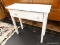 (R1) ACCENT TABLE; WHITE PAINTED WOODEN SOFA/ACCENT TABLE WITH A SINGLE DRAWER. MEASURES 29.5 IN X