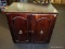 (R2) WOODEN NIGHTSTAND; DARK STAINED WOODEN NIGHT STAND WITH 2 LOCKING LATCH FRONT DOORS WITH RING