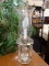 (R2) TABLE LAMP; GLASS FAUX CANDLE STICK TABLE LAMP WITH A FLOWER ETCHED GLASS CHIMNEY. MEASURES