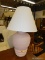 (R2) TABLE LAMP; PINK PAINTED POTTERY ART TABLE LAMP WITH A WHITE COOLIE LAMP SHADE. MEASURES 29 IN