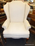 (R2) WINGBACK CHAIR; CREAM ZEBRA TEXTURE FABRIC WINGBACK CHAIR WITH ROLL ARMS AND QUEEN ANNE LEGS.