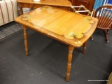 (R3) KITCHEN TABLE; WOODEN TABLE WITH A SMOKEY PAINT AROUND THE RIM WITH CLOVER DETAILING ON THE