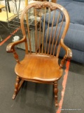 (R3) ROCKING CHAIR; VINTAGE WOODEN ROCKING CHAIR WITH A BANNISTER BACK AND SCROLL ARMS. HAS TURNED