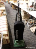 (R3) SIMPLICITY VACUUM; UPRIGHT, SIMPLICITY FREEDOM VACUUM WITH A BLACK BAG AND GREEN BOTTOM. SELLS