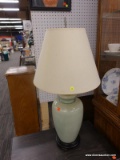 (R4) TABLE LAMP; GREEN CRACKLE POTTERY TABLE LAMP SITTING ON A BLACK PAINTED WOODEN STAND WITH A