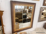 (WALL) WALL HANGING MIRROR; BEVELED MIRROR IN A LARGE WOODEN FRAME WITH A FADING COLOR AS YOU GET