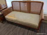 (DOOR) WICKER LOVESEAT; WOODEN LOVESEAT WITH A WICKER LACED BACK AND SIDES AND ROLL ARMS. HAS A