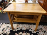 (R1) BREAKFAST TABLE; WOODEN TABLE WITH A LOWER SHELF. MEASURES 3 FT X 1 T 11.5 IN X 28.75 IN.