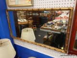 (BWALL) FRAMED WALL MIRROR; RECTANGULAR BEVELED MIRROR FRAMED IN A GOLD GILT BAMBOO-LOOK FRAME.