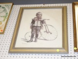 (BWALL) FRAMED PRINT; DEPICTS A COLONIAL KID STANDING NEXT TO A LARGE FRONT WHEEL TRICYCLE. SIGNED