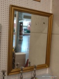(BWALL) WALL HANGING MIRROR; MIRROR SITS IN A GOLD TONE PAINTED WOODEN FRAME. MEASURES 30.25 IN X 28