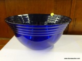 (R1) GLASS BOWL; LARGE BLUE GLASS BOWL. MEASURES 5 IN TALL WITH A 12 IN DIAMETER.