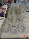 (TABLE) LOT OF PLASTIC DRINKWARE; LOT INCLUDES 26 ASSORTED CLEAR PLASTIC DRINK WARE. SOME ARE
