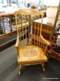 (R2) ROCKING CHAIR; WOODEN ROCKING CHAIR WITH A BANNISTER BACK AND A SCROLL TOP. MEASURES 21 IN X