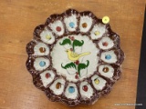 (R2) DEVILED EGG PLATE; HAND PAINTED DEVILED EGG PLATE WITH A BIRD IN THE MIDDLE.