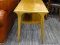 (R2) MID-CENTURY MODERN TABLE; WOODEN COFFEE TABLE WITH A LOWER SHELF AND ROUNDED/SQUARISH LEGS.