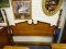(R3) QUEEN SIZE HEADBOARD; HAS A BROKEN ARCH PEDIMENT TOP WITH TURNED POLE BED POSTS. MEASURES 61.5