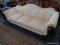 (R3) ANTIQUE 3 CUSHION SOFA; HAS A FLORAL CARVED CREST, SWAN THEMED ARM SUPPORTS, AND CREAM COLORED