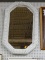 (BACK WALL) OCTAGONAL MIRROR; WHITE WICKER FRAMED MIRROR IN EXCELLENT CONDITION. MEASURES 19 IN X 38