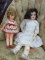 (WALL) PAIR OF DOLLS; 2 VINTAGE DOLLS TO INCLUDE A DOLL IN A WHITE DRESS WITH CURLY DARK BROWN HAIR