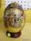 (R1) SATSUMA EGG; HAND PAINTED SATSUMA DECORATIVE EGG WITH A SCENE SHOWING 8 GEISHAS GOSSIPING AND